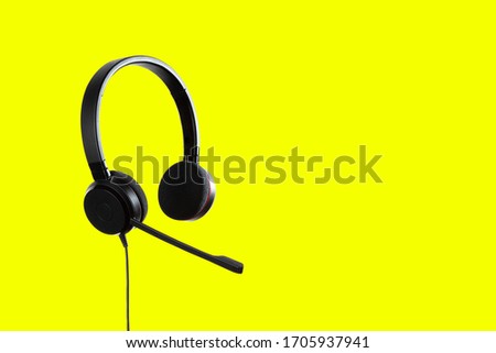 Headphones with a microphone for IP telephony call center on a yellow background Royalty-Free Stock Photo #1705937941