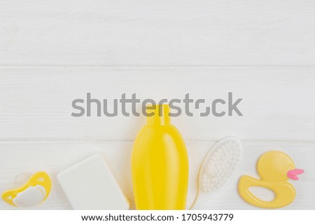 Baby accessories for hygiene and rubber toy isolated on white.