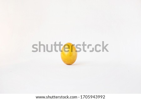 A lonely golden egg on a white background. Easter golden egg. Alone on holiday