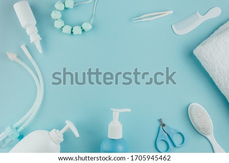 Children's personal care kit. Baby's accessories on blue background, top view.