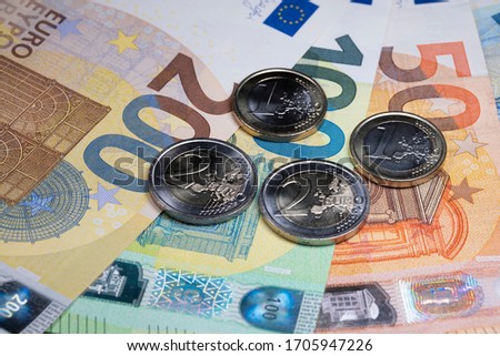 Euro banknotes from fifty to two hundred and Euro coins. European monetary union currency. Economic stimulus package