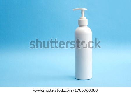 A bottle of sanitizing gel or liquid for washing hands. Cleanliness and body care concept.