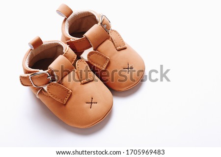 Pair of brown leather kids shoes on white background. Royalty-Free Stock Photo #1705969483
