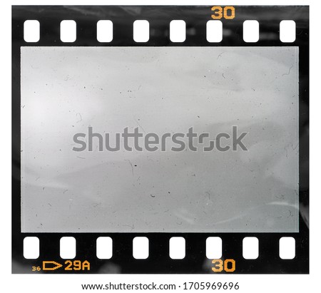 real macro photo of blank 35mm film frame or filmstripe on white background, retro photo placeholder, your photo here.