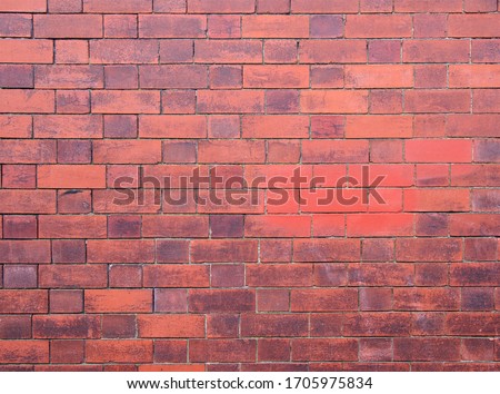 an old exterior wall made of dark red bricks
