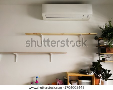 Empty wooden shelves with white bracket on the wall in the house.