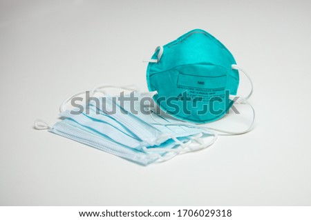 A closeup of an assortment of protective face masks. One N95 and three surgical masks. Royalty-Free Stock Photo #1706029318