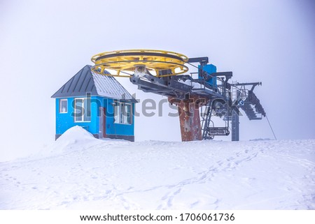 Cold Winter in Jermuk City, Yellow ropeway in mountain, blue bulid near ropeway as a reception, cold weather for tourists