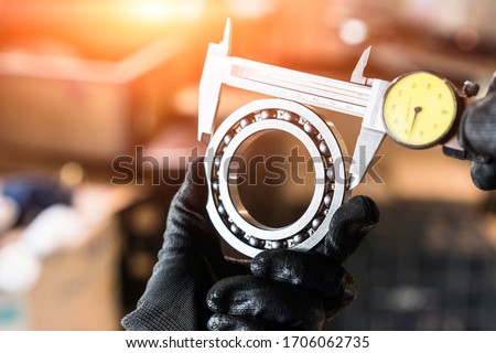 Engineer technician measure a ball bearing
with vernier caliper, engineering Engine manufacturing factory Industry. Industrial Concept  Royalty-Free Stock Photo #1706062735
