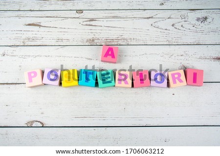 "a posteriori"-the words on wooden cubes.  A background image of english words on colorful building blocks.