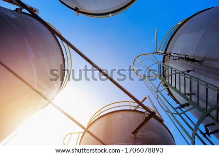 Stainless tanks and pipeline for liquid chemical industrial on blue sky background Royalty-Free Stock Photo #1706078893