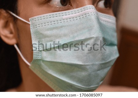 close up of women with surgical medical facemask protection coronavirus covid-19