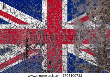 National flag of United Kingdom on old peeling wall background.The concept of national pride and symbol of the country.
