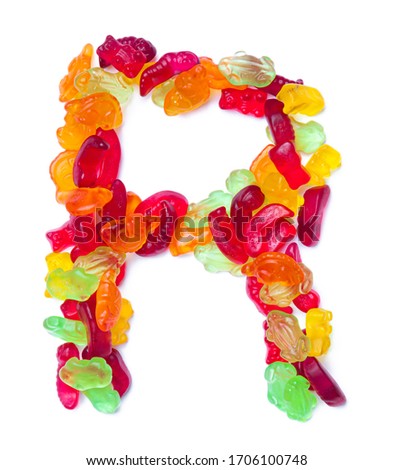 Letter R of the English alphabet  from multi-colored marmalade on a white isolated background. Food pattern made ffrom children's sweets bears, dinosaur, snake and frog.Bright alphabet for kids design