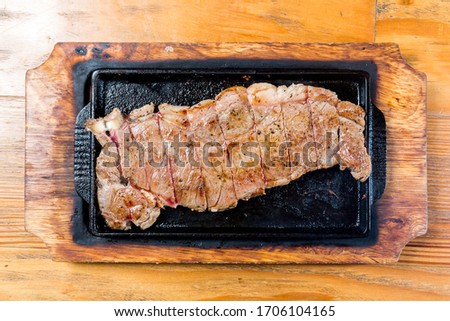 Pork steak fried on a hot pan, very fragrant