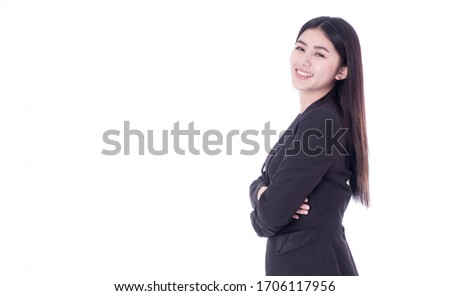 An Asian businesswoman stands happily facing her arm in the white background. Concept of young business woman. There's a coyp space and be isolated.