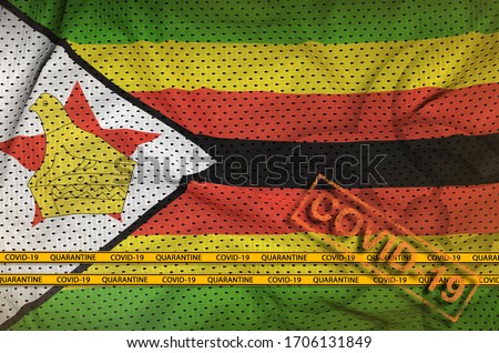 Zimbabwe flag and orange Covid-19 stamp with border tape. Coronavirus or 2019-nCov virus concept