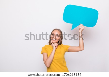 Young beautiful girl holding a green bubble for text, on a white background