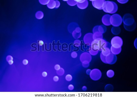 Glowing colored blurred dots. Colored fantasies. Bokeh. Abstract colored background. Glowing fiber optic filaments.