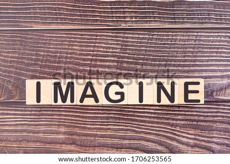 IMAGINE word made with wood building blocks.
