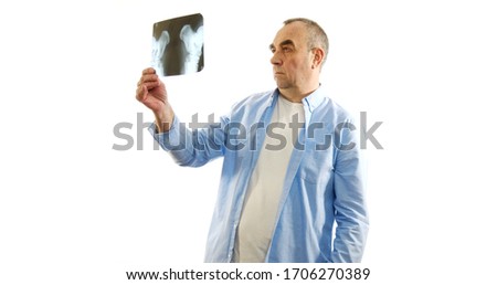 A man examines the X-rays. White background.