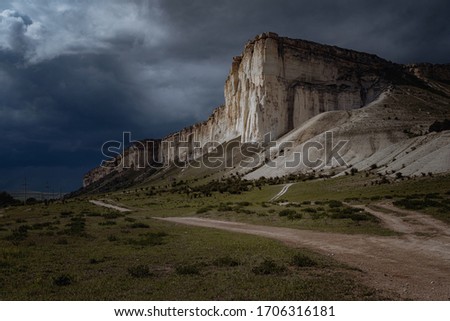Wonderful view of the rain clouds over the Rock. Dramatic and picturesque scene. Location place White rock, Belogorsk , Crimea, Ukraine, Europe. Artistic picture. Beauty world.