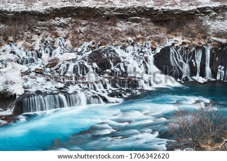 Hraunfossar, a waterfall formed by rivulets streaming over Hallmundarhraun, a lava field from volcano lying under the glacier Langjokull, and pour into the Hvita river, Iceland