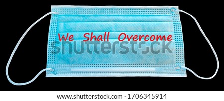 Digital composite conceptual image symbolizes unprecedented challenge of 21 century, medical mask with text- we shall overcome - mask selected on black background