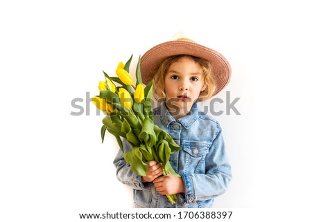 Lifestyle portrait of happy playful little child girl holding bouquet  yellow tulips as gift for mother's day father's day birthday anniversary cutout on white background copy space. Summer vacation.