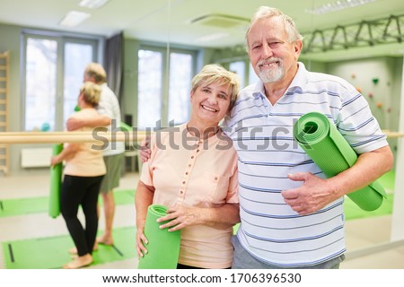 Happy couple seniors is looking forward to the yoga class or gymnastics class in the gym