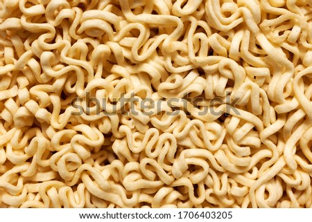 Macro instant raw noodle. Close-up uncooked ramen texture. Food background, top view