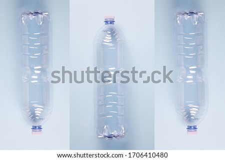 an artsy minimalistic compostion of three empty plastic bottles against a pastel light blue background, flat lay, studio shot