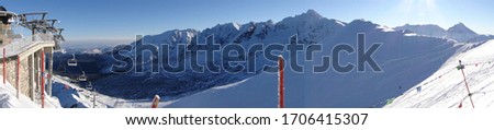 Kasprowy Wierch on top of the mountain in winter clear blue sky day - panorama picture with cable car and mountains view