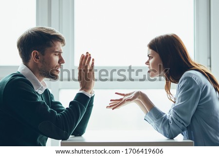 A man and a woman are sitting at a table chatting to a work colleague Royalty-Free Stock Photo #1706419606
