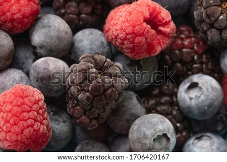 a beautiful close up photograph of fruit, with raspberries, blueberries and blackberries, studio shot