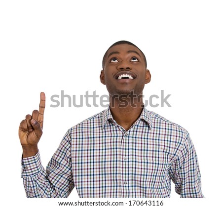 Closeup portrait of young man pointing up looking at something above showing with index finger , isolated on white background. Positive human emotions, facial expressions, feelings, symbols, signs