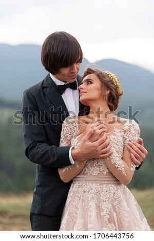 The bride and groom celebrate their wedding in the mountains. Wedding photography. Wedding ceremony for two.