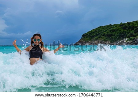 A girl enjoy with the wave on the beach
