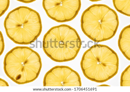 a very interesting pattern of transparent lemon slices against a bright white background