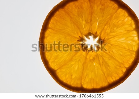 a beautiful orange slice against a bright white background, flatlay, copyspace