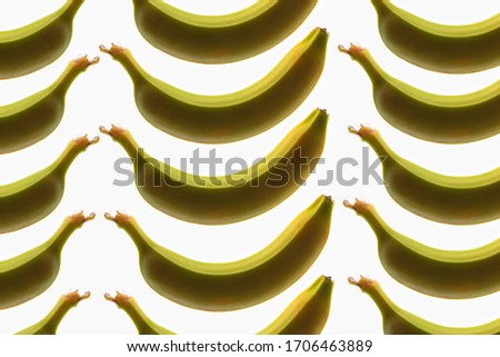 a wonderful image of an interesting pattern of bananas, against a bright white background, flatlay