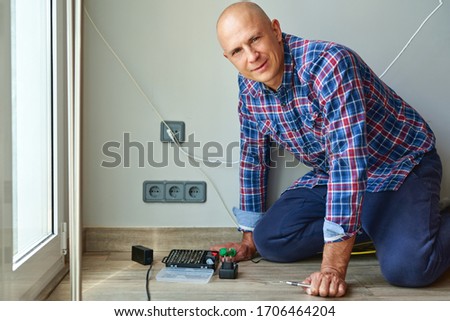 Electrician Installing Socket at Home