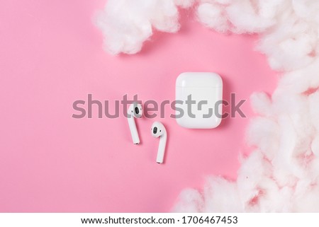 Air Pods. with Wireless Charging Case. New Airpods 2019 on pink background.EarPods. Airpods. Copy space.