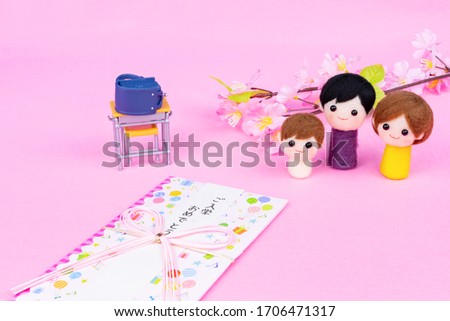 Study desk, school bag, cherry blossoms and dolls (Entrance image).
Translation on paper's text:"Congratulations on your enrollment".(image of entrance)