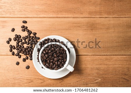 Top view flat lay coffee bean in cup on wooden.