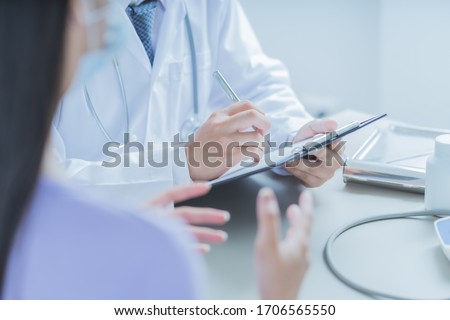 Doctors and patient talking about therapy. Asian people Royalty-Free Stock Photo #1706565550