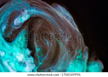 Abstract background with natural texture of colorful blue flows in the dark. Expressive swirls with oceanic colors mixing in the dark.
