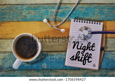 Conceptual photo of coffee, stethoscope and notepad on the vintage background. Night shift among Frontliners during pandemic of Covid-19  Royalty-Free Stock Photo #1706598427