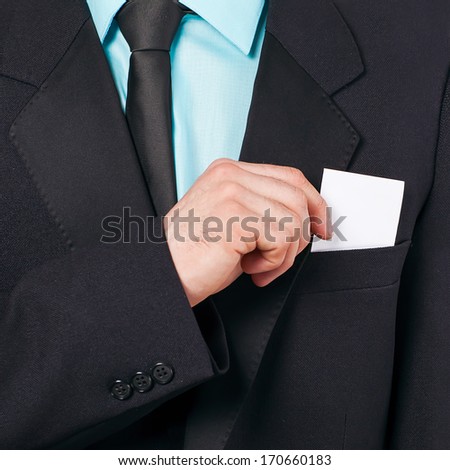 Part of body of business man who takes out business card from the pocket of business suit, copyspace