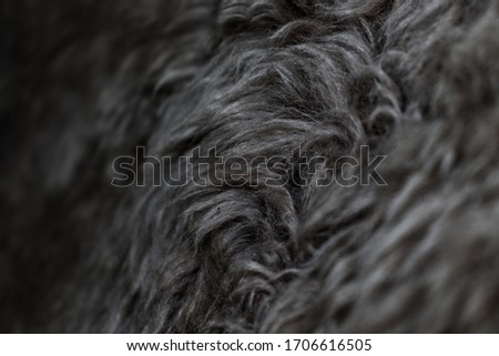 Closeup dark black and white image of fake fur.